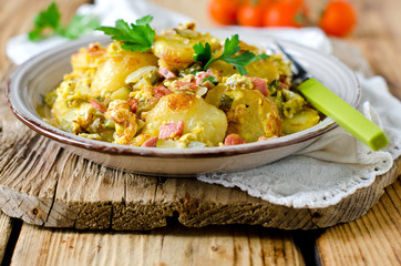 Fried potatoes with ham and pickles