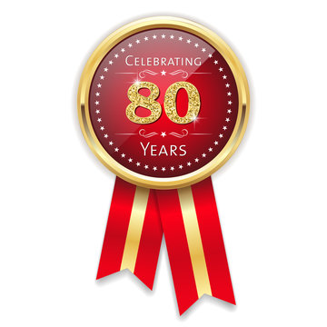 Red celebrating 80 years badge, rosette with gold border and ribbon