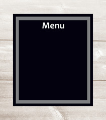 Black menu paper sheet on a light wooden background design template.