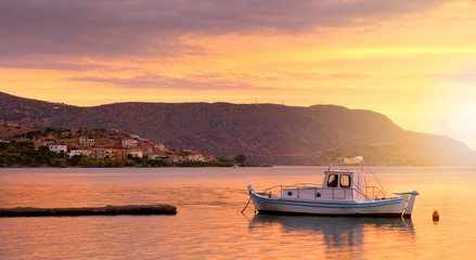 Fototapeta na wymiar White boat at the pier in the bay. Crete