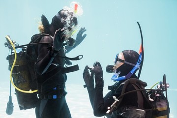 Man proposing marriage in scuba gear