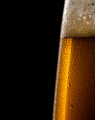 Water drops on a glass of beer.