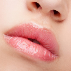 Close-up shot of female lips with healthy skin and rose color li - obrazy, fototapety, plakaty