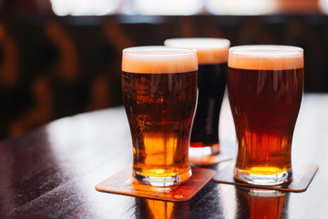 Glasses of light and dark beer on a pub background. - 105422701