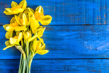 Beautiful daffodils flowers bouquet selected on wooden table