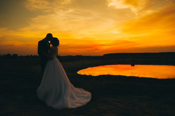 wedding couple on the background of sunset