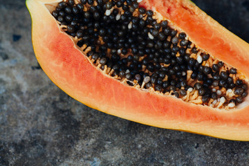 sliced papaya fruit on black background