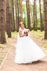 Fototapeta na wymiar Beautiful bride with bouquet of flowers outdoor