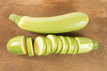 Cut zucchinis isolated on a wooden background