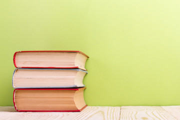 Old books on a wooden shelf.