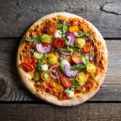 Pizza with arugula and cherry tomatoes