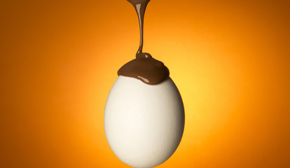 egg  with chocolate isolated on orange background