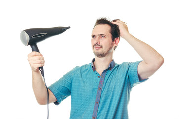 The man dries hair the hair dryer.