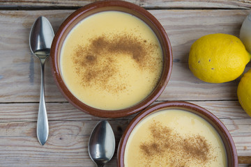 Traditional creme brulee on ceramic dish on wooden table