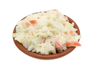 Bowl of surimi crab meat with mayonnaise isolated on a white background. © Bert Folsom