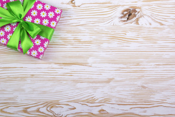 Gift box with ribbon on wooden table