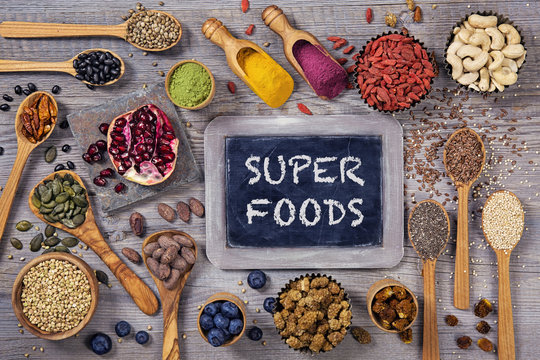 Super foods in spoons and bowls