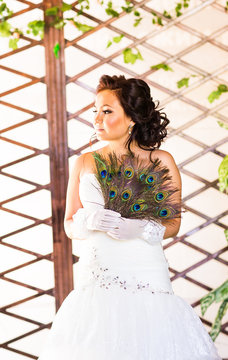 Bride  close up with  fan made of peacock feather