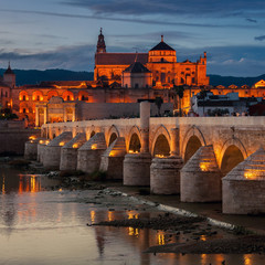 Roman bridge and La Mezquita at sunset in Cordoba