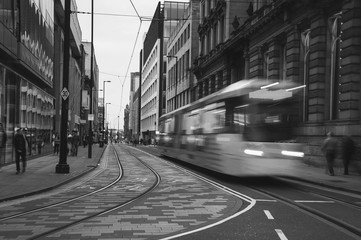 Yellow tram in Manchester, UK in the evening