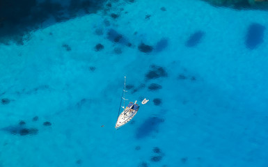 Aerial view of single yacht in azure sea