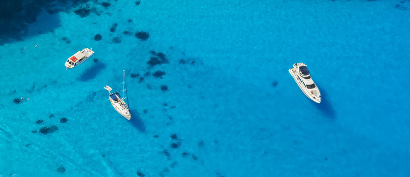 Aerial view of yachts in azure sea