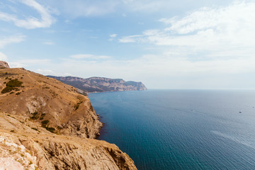 High stony coast at deep blue sea