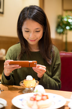 Woman take photo on her dessert
