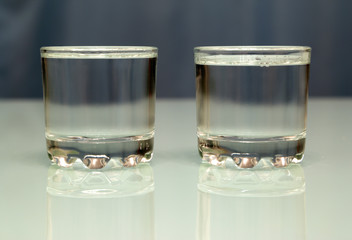 two glasses with vodka on table
