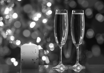 glasses with champagne and candle