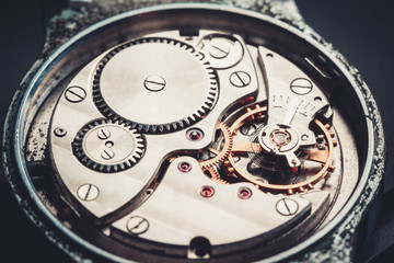 Fototapeta na wymiar mechanism antique vintage wrist watch beautiful original black and metallic background
