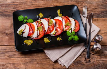 Caprese Salad on black plate