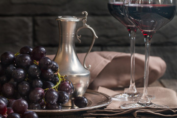 Refined still life of red wine and grapes