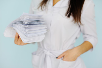 woman doctor with a bundle of sheets. Nurse with sick leave
