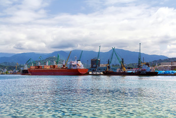 Fototapeta premium Container ship and fishing boat in the seaport