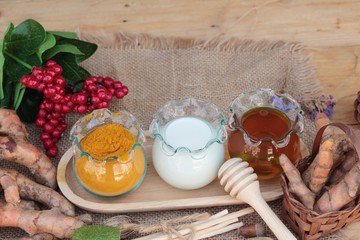 Turmeric powder with honey and milk for scrub.