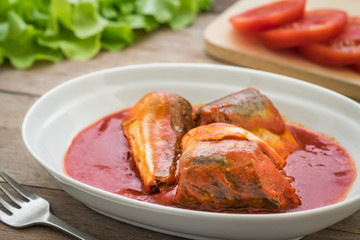 Canned fish in tomato sauce on plate