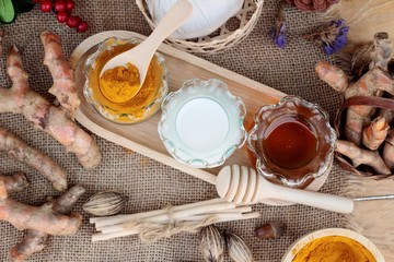 Turmeric powder with honey and milk for scrub.