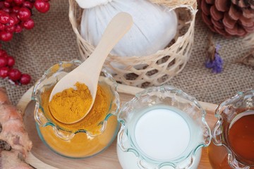 Turmeric powder with honey and milk for scrub.