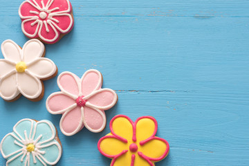 Happy Easter  (home-baked cookies) 
Flower shaped gingerbread cookies on a blue wooden table.
