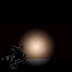 Heavy motorcycle front light on a wooden fence in the night