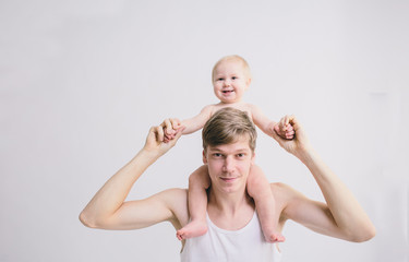 man playing with his baby on white background