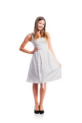 Girl in black-and-white dotted dress, heels, studio shot