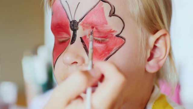 The girl applied a festive make-up in the form of butterflies