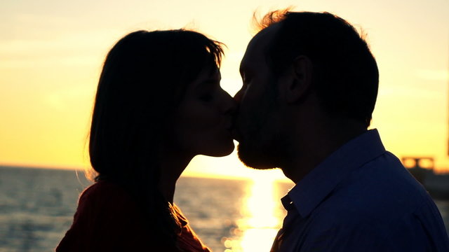 Young couple in love, kissing on beach during sunset, super slow motion 240fps

