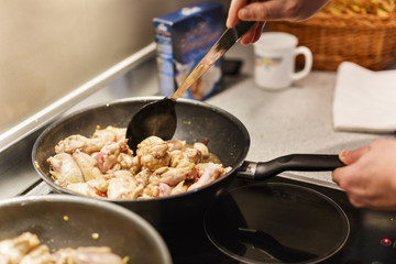 pan with chicken wings on the stove
