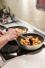 pan with chicken wings on the stove