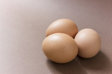 Brown eggs on a brown background