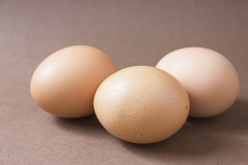 Brown eggs on a brown background