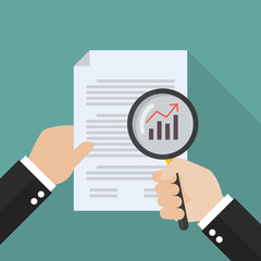 Hand holding magnifying glass with document paper